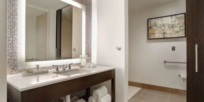 Private guest bathroom with free toiletries at Hilton Dallas/ Plano Granite Park.