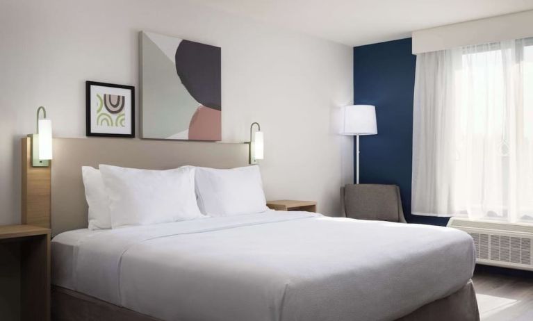 Day use room with king bed and tv at Spark By Hilton Guelph.