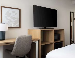 Day use room with king bed and tv at Spark By Hilton Guelph.