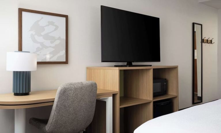 Day use room with king bed and tv at Spark By Hilton Guelph.