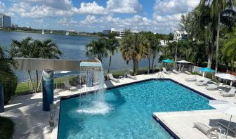 Refreshing outdoor pool with an amazing view of the lake at Pullman Miami Airport.