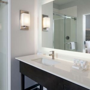 Guest bathroom with shower at Homewood Suites By Hilton LAX Airport.