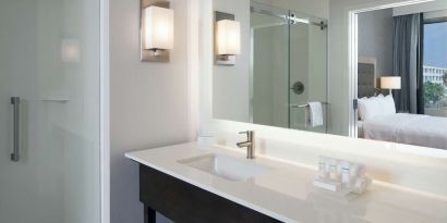 Guest bathroom with shower at Homewood Suites By Hilton LAX Airport.