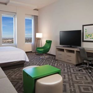 Day use room with work desk and sofa at Homewood Suites By Hilton LAX Airport.
