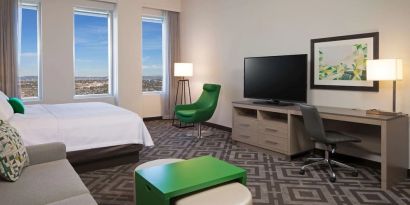 Day use room with work desk and sofa at Homewood Suites By Hilton LAX Airport.