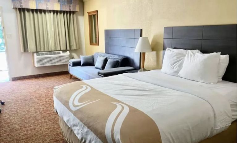 King bed with AC at Hibiscus Inn & Suites.
