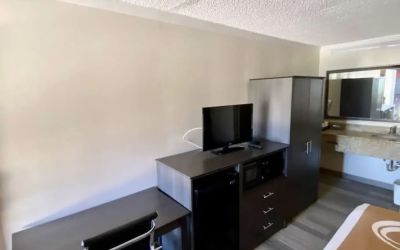 Desk and TV at Hibiscus Inn & Suites.