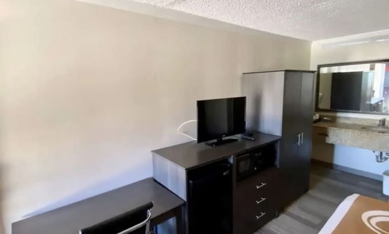 Desk and TV at Hibiscus Inn & Suites.