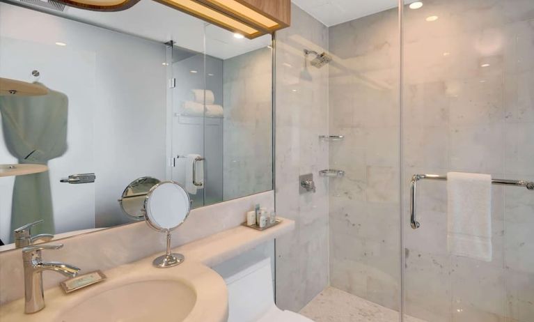 Private guest bathroom with shower and free toiletries at Wyndham Garden Brooklyn Sunset Park.