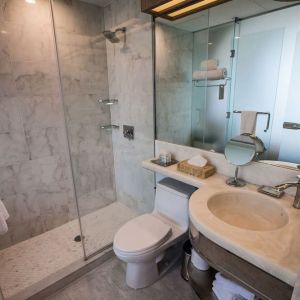 Private guest bathroom with shower and free toiletries at Wyndham Garden Brooklyn Sunset Park.