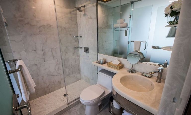 Private guest bathroom with shower and free toiletries at Wyndham Garden Brooklyn Sunset Park.