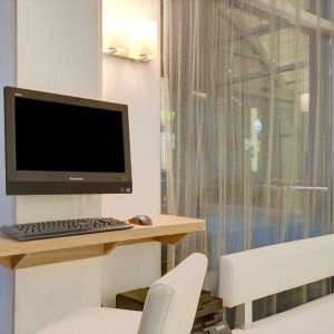 Business center with computer, printer and comfortable seating at Wyndham Garden Brooklyn Sunset Park.