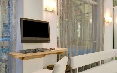 Business center with computer, printer and comfortable seating at Wyndham Garden Brooklyn Sunset Park.