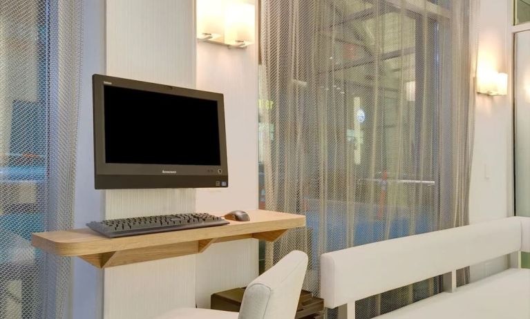Business center with computer, printer and comfortable seating at Wyndham Garden Brooklyn Sunset Park.