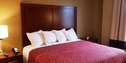 King bed at Days Inn By Wyndham Brooklyn Marine Park.