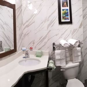 Private guest bathroom with shower and free toiletries at Days Inn By Wyndham Brooklyn Marine Park.