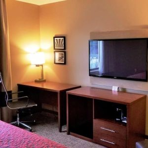 Day use room' workspace with TV screen, work desk and ergonomic chair at Days Inn By Wyndham Brooklyn Marine Park.