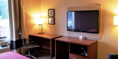 Day use room' workspace with TV screen, work desk and ergonomic chair at Days Inn By Wyndham Brooklyn Marine Park.