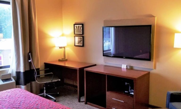 Day use room' workspace with TV screen, work desk and ergonomic chair at Days Inn By Wyndham Brooklyn Marine Park.