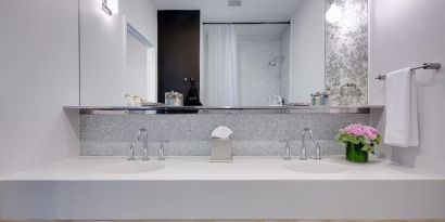 Private guest bathroom with shower and free toiletries at Nu Hotel - Brooklyn.
