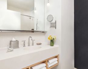 Private guest bathroom with shower and free toiletries at Nu Hotel - Brooklyn.