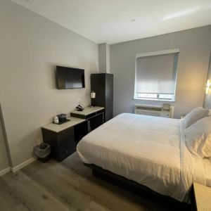 Standard room with king bed and workspace at King Hotel Brooklyn.