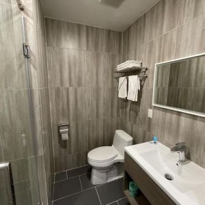 Private guest bathroom with shower and free toiletries at King Hotel Brooklyn.