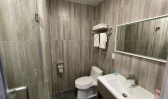 Private guest bathroom with shower and free toiletries at King Hotel Brooklyn.