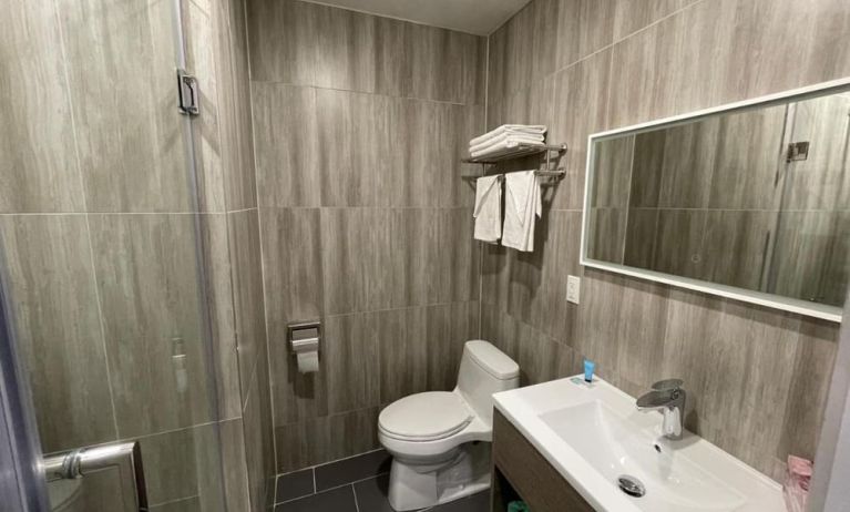 Private guest bathroom with shower and free toiletries at King Hotel Brooklyn.