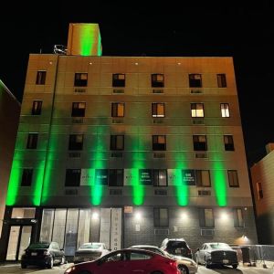 Exterior of King Hotel Brooklyn and parking area,