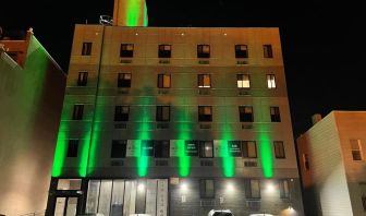 Exterior of King Hotel Brooklyn and parking area,