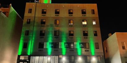 Exterior of King Hotel Brooklyn and parking area,