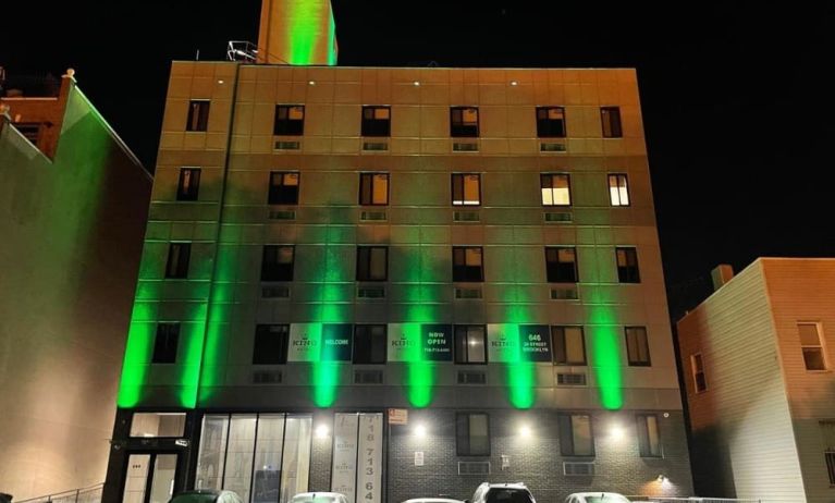 Exterior of King Hotel Brooklyn and parking area,