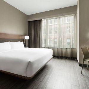 Standard day use room with king bed, large windows, work desk and private bathroom at AC Hotel New York Times Square.