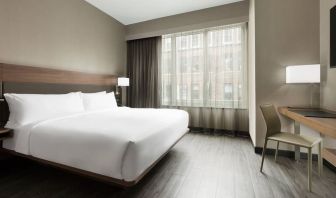 Standard day use room with king bed, large windows, work desk and private bathroom at AC Hotel New York Times Square.