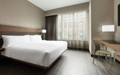 Standard day use room with king bed, large windows, work desk and private bathroom at AC Hotel New York Times Square.