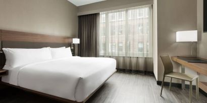 Standard day use room with king bed, large windows, work desk and private bathroom at AC Hotel New York Times Square.