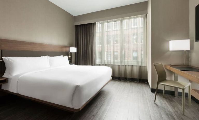 Standard day use room with king bed, large windows, work desk and private bathroom at AC Hotel New York Times Square.