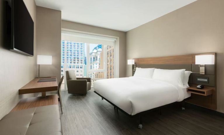 Day use room with workspace, large windows and private bathroom at AC Hotel New York Times Square.