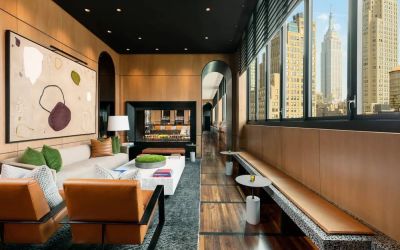 Lounge seating and workspace with fireplace at AC Hotel New York Times Square.