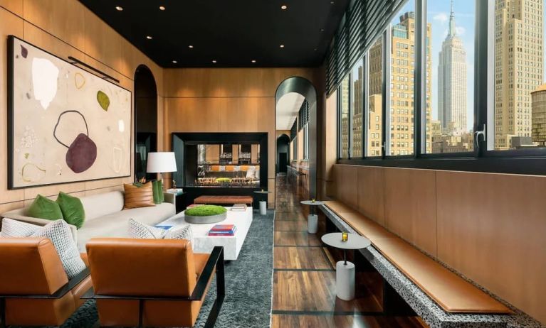 Lounge seating and workspace with fireplace at AC Hotel New York Times Square.