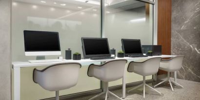 Business center with cmputers, printer and ergonomic chairs at AC Hotel New York Times Square.