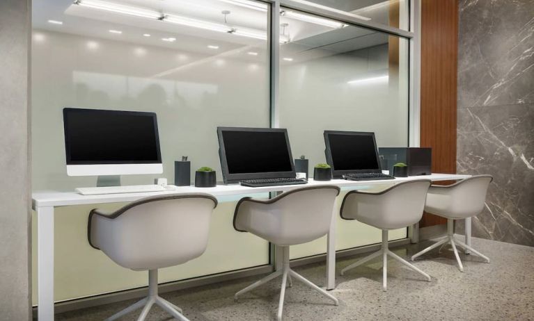 Business center with cmputers, printer and ergonomic chairs at AC Hotel New York Times Square.