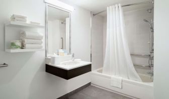 Private guest bathroom with combine shower and tub at Hampton Inn Manhattan Chelsea.