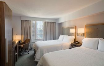 Day use twin room with work desk, large windows and private bathroom at Hampton Inn Manhattan Chelsea.
