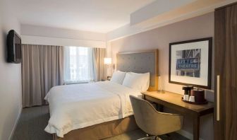 Day use room with king bed, work desk, natural light and private bathroom at Hampton Inn Manhattan - Madison Square Garden.