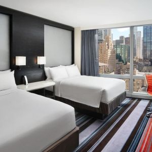 Day use twin room with work desk and floor to ceiling window at Courtyard By Marriott New York Manhattan/Central Park.