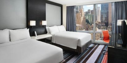 Day use twin room with work desk and floor to ceiling window at Courtyard By Marriott New York Manhattan/Central Park.