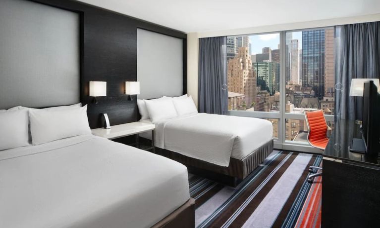 Day use twin room with work desk and floor to ceiling window at Courtyard By Marriott New York Manhattan/Central Park.
