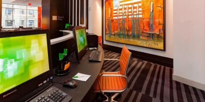 Business center with computers, printer and ergonomic chairs at Courtyard By Marriott New York Manhattan/Central Park.